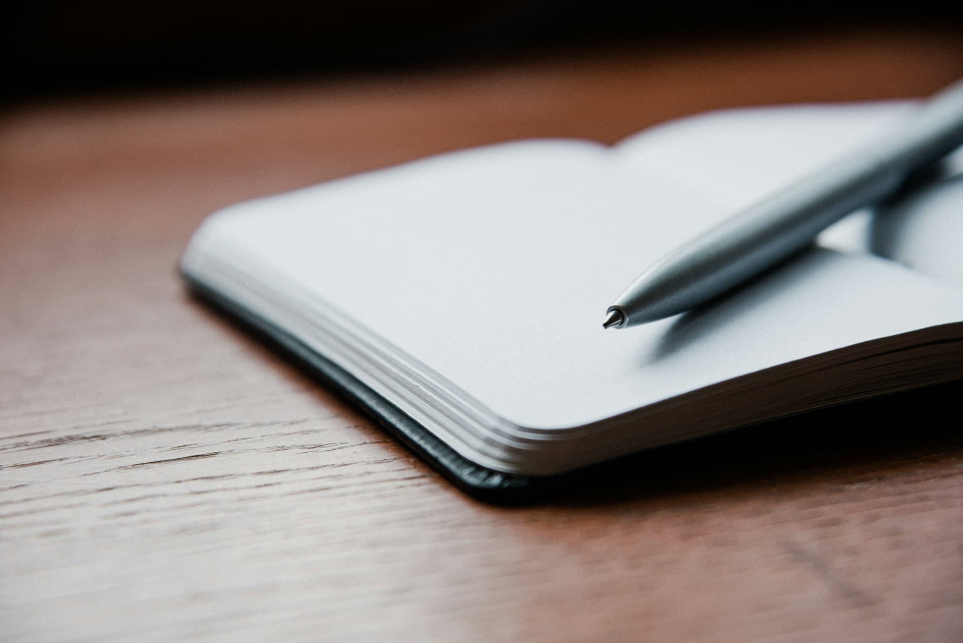 Notebook and pen on a warm timber surface: the careful preparation behind a criminal defence